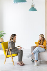 Woman psychologist works with teenage girl in her office. Mental health.