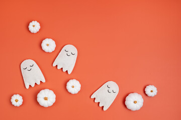 Top view of Halloween decoration with pumpkins and ghosts. Party, invitation, halloween decoration concept. Flat lay, overhead, copy space.