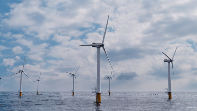 Wind Turbines. Offshore Wind Farm on a Cloudy Afternoon. Environmental Energy Concept.