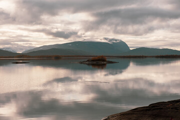 Clear lake with mountain reflection and clouds