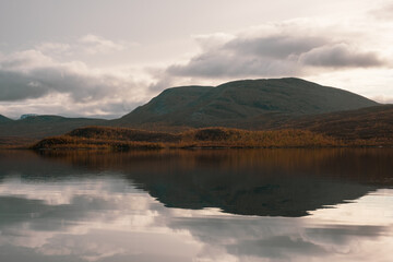 Clear lake with mountain reflection and clouds