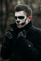 The image of a skeleton on Halloween in the park. Male image for Halloween. A man in the image of...