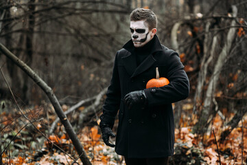 The image of a skeleton on Halloween in the park. Male image for Halloween. A man in the image of...