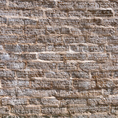 Old brick wall made of sandstone bricks as a natural background