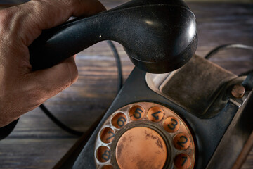 Classic telephone vintage color, dialing or scrolling phone on wooden table