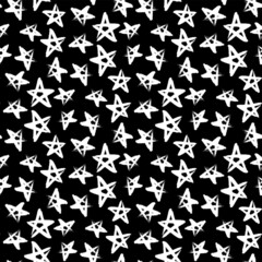 Beautiful small ink white stars isolated on dark black background. Cute monochrome starry seamless pattern. Vector simple flat graphic hand drawn illustration. Texture.