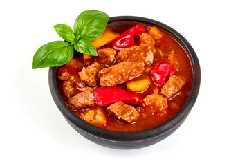 Hungarian goulash, meat stew in a rustic pot, isolated on white background.