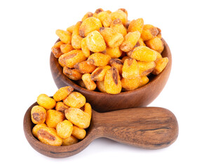 Roasted salted corn nuts in wooden bowl and spoon, isolated on white background. Beer snack, dry corn with spices.