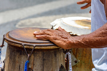 Musician playing a traditional Brazilian percussion instrument called atabaque during a capoeira...