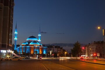 Naklejka na ściany i meble Konya. Turkey. Blue lights on mosque and long exposure photo of cars on city and center of Konya at night. 