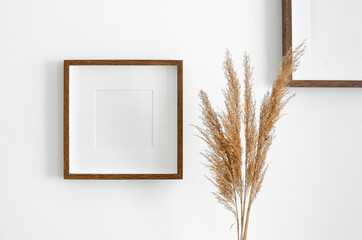 Square wooden frame mockup for artwork, photo, print and painting presentation. White interior...