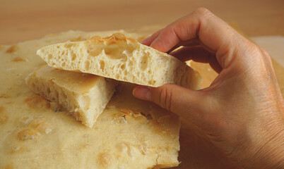 A light loaf of bread dough in a woman hand