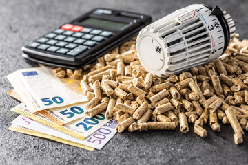 Ecological heating. Wooden pellets, euro banknotes, calculator and thermostatic head. - obrazy, fototapety, plakaty