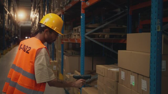 Man scanning barcodes in warehouse