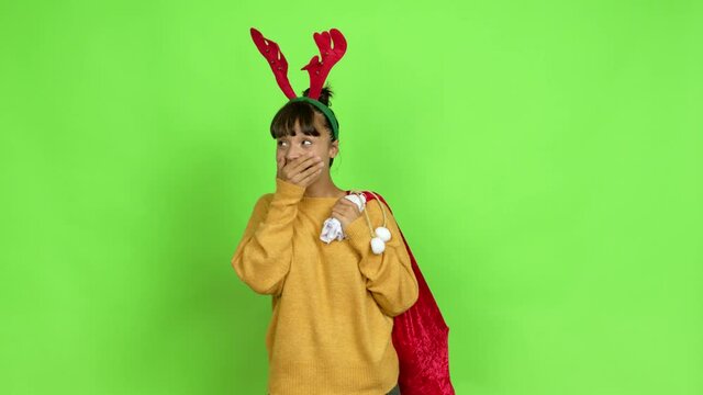 Young woman with christmas hat intending to realizes the solution while lifting a finger up over isolated background. Green screen chroma key