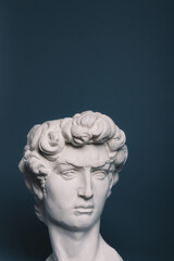 Gypsum copy of the sculpture David Michelangelo on gray background
