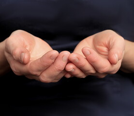 hands praying together on black background  stock photo