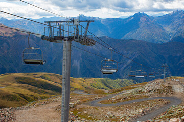Cable car with open seats in the mountains in summer. Ski lift in the Caucasus in Georgia. View...