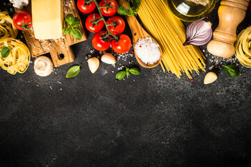 Italian food background on black. Raw Pasta, fresh tomatoes, olive oil, spices and basil. Top view with copy space.