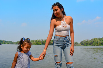 Young mother with her daughter having a great day  in a hot day. Outdoor Photos