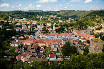 Fototapeta na wymiar Vranov nad dyji, Southern Moravia, Czech Republic, 03 July 2021: medieval town on river bank, Narrow picturesque street with gothic, renaissance and baroque historical buildings at summer sunny day