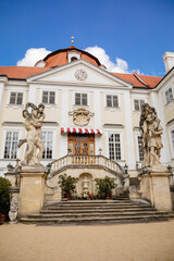Obraz premium Vranov nad dyji, Southern Moravia, Czech Republic, 03 July 2021: entrance to baroque and gothic medieval castle on hill at sunny summer day, courtyard with antique statues, stairs next to fountain