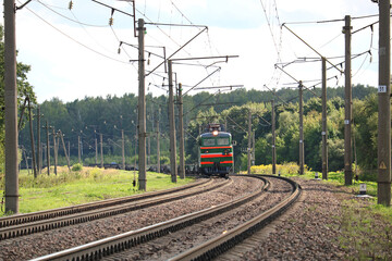 Fototapeta premium electric locomotive with a train of empty fitting platforms