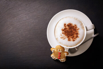 christmas cookie and cup of cappuccino on dark background,