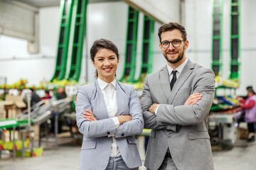 Portrait of business people. A man and a woman well dressed in an elegant suit pose for a photo in...