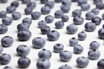 Blueberries with shadows on white table