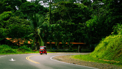 Red Tuk tuk on the jungle road in Costa Rica. Punta Uva, Puerto Viejo, Limon. 