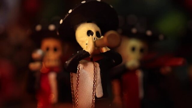 placing mariachi figure in traditional mexican offering to celebrate Day of the Dead in Mexico
