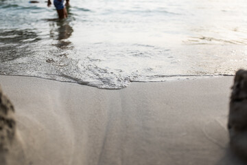 Wave sea water shore edge on the sand of a Mediterranean beach