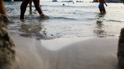 Fototapeta na wymiar Wave sea water shore edge on the sand of a Mediterranean beach