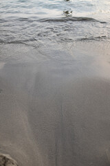 Wave sea water shore edge on the sand of a Mediterranean beach