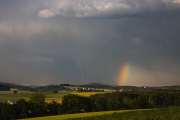 Rainbow with a lightning strike