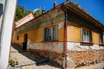 Trebic, Bohemia, Czech Republic, 06 July 2021: Narrow picturesque street with colorful buildings in historic center in medieval city, renaissance and baroque historical buildings at summer sunny day
