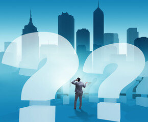 Obraz premium Businessman in uncertainty concept with question marks