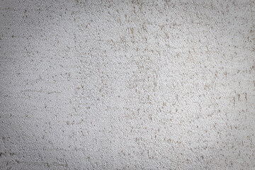 Rough cement wall full of holes