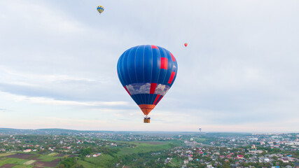 Fototapeta premium How to travel during quarantine. Hot air balloon. Colorful hot-air balloons flying over the village
