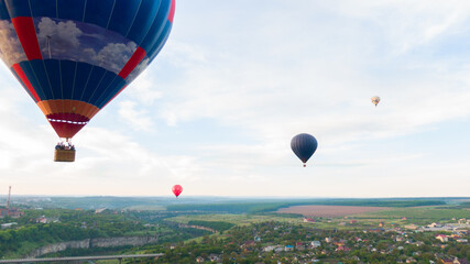 Fototapeta premium How to travel during quarantine. Hot air balloon. Colorful hot-air balloons flying over the village
