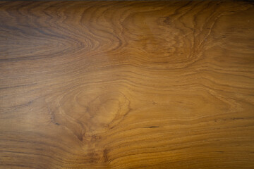 Fototapeta premium The teak wood background is coated with a matt lacquer showing the wood grain.