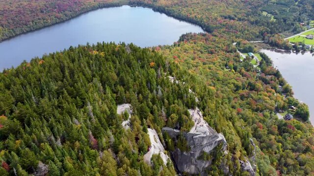 Aerial footage of a mountain with a lake (Mont Pinacle - Quebec)