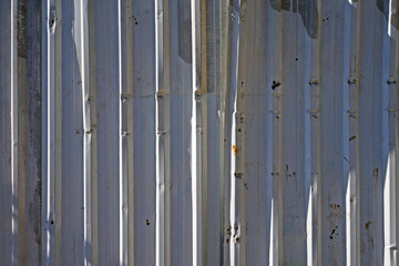 Corrugated metal plates surrounding wasteland 