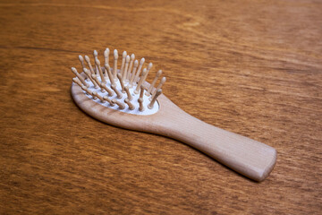 Wooden hairbrush lies on the table