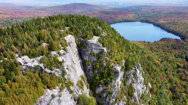 Aerial footage of a mountain with a lake (Mont Pinacle - Quebec)
