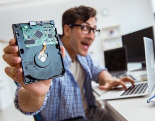 Technician with broken hard drive