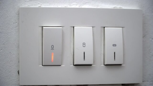 Female hand turning on light on electrical decorative bathroom light switches