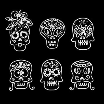 Collection of vector linear illustrations of decorated skulls of different types on black background for Halloween celebration concept designs