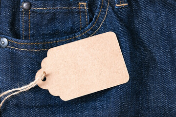 Craft blank label on dark blue jeans background, sale and discount concept